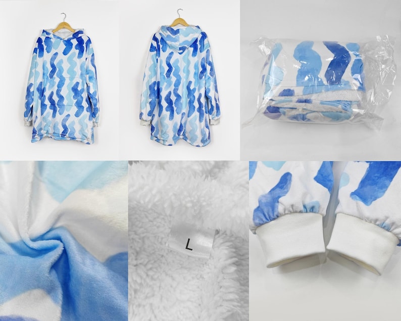 Puede incluir: Una manta con capucha azul y blanca con un patr&oacute;n ondulado. La manta est&aacute; hecha de suave felpa y tiene una capucha grande. La manta se muestra doblada y en una bolsa de pl&aacute;stico.