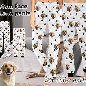 May include: White pyjama trousers with a repeating pattern of a dog's face and a four-leaf clover. The text "Custom Face Pajama pants" is at the top of the image. The text "28 colour options" is at the bottom of the image.