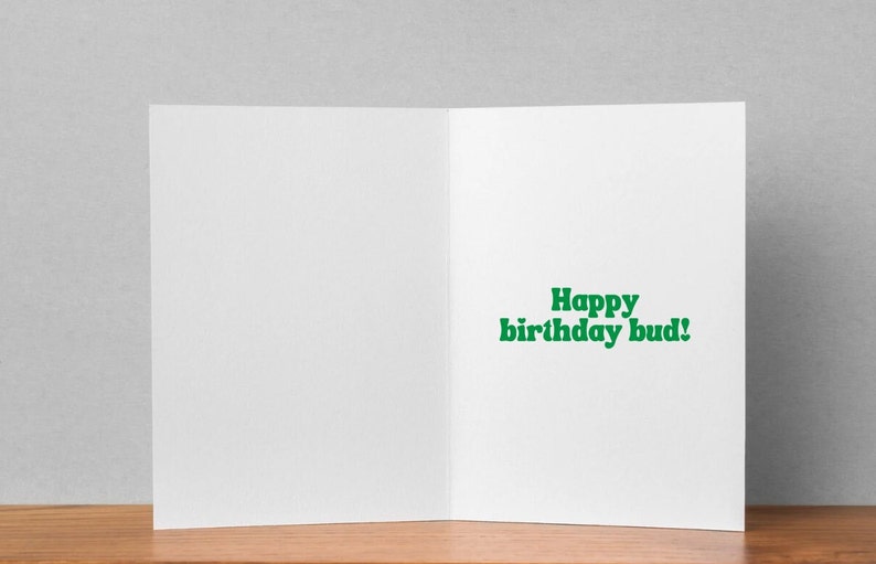 May include: A blank white card with a green greeting that reads "Happy birthday bud!"