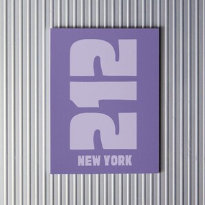 May include: A purple card with the number 212 in white, bold font. The text "NEW YORK" is printed in white below the number.