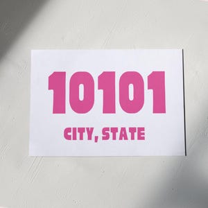 May include: A white card with the number 10101 printed in large, bold, pink letters. The text "CITY, STATE" is printed below the number in smaller, pink letters.