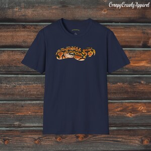 May include: A navy blue t-shirt with a graphic of a brown and orange snake.