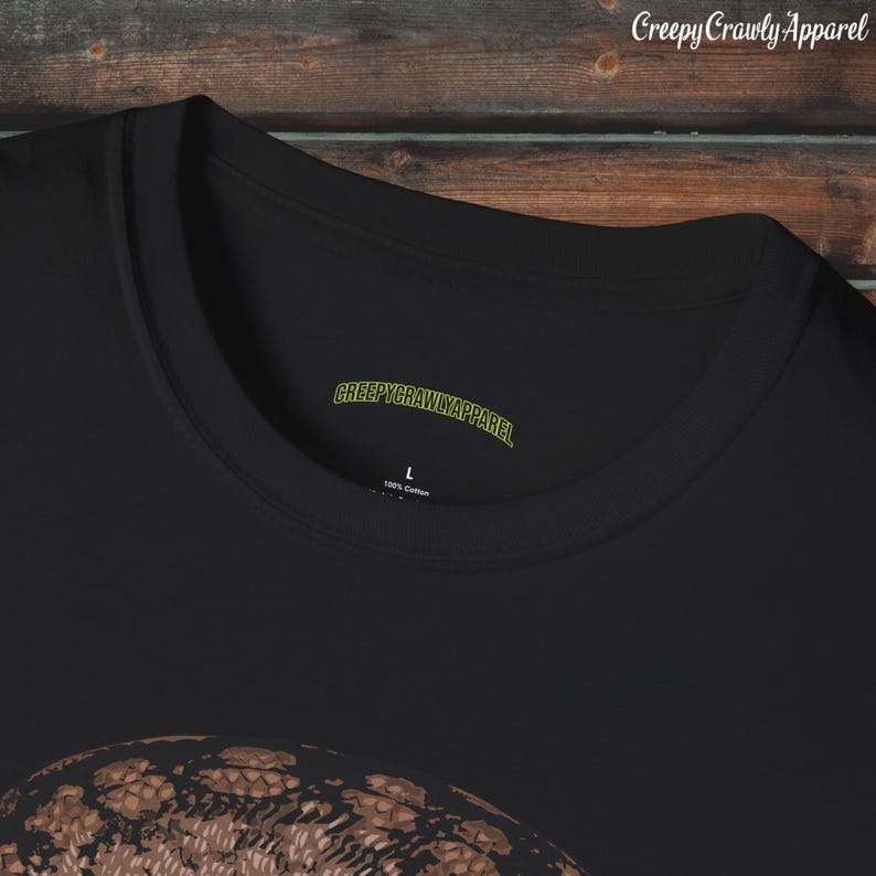 May include: Black t-shirt with a brown snake graphic and the text "CreepyCrawlyApparel" on the neck label.