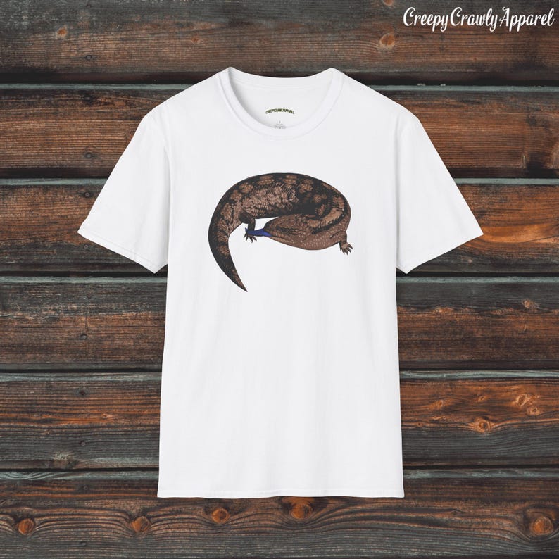 May include: White t-shirt with a brown and black lizard graphic. The lizard is curled up with its tail in its mouth.