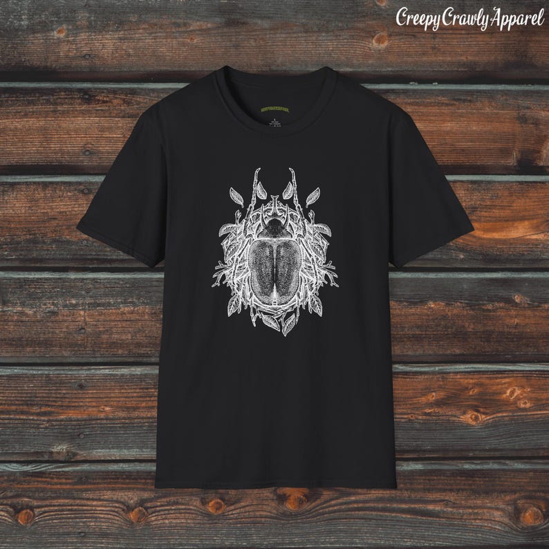 May include: Black t-shirt with a white graphic print of a beetle surrounded by leaves.