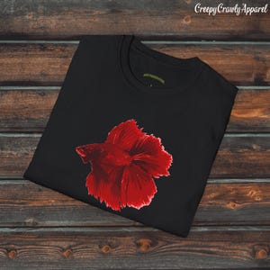 May include: Black t-shirt with a red betta fish graphic. The fish is in a side profile with its fins spread out.