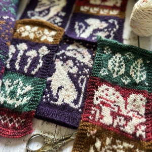 Pode incluir: Uma cole&ccedil;&atilde;o de quadrados de malha com v&aacute;rios desenhos, incluindo um gato branco, cogumelos e padr&otilde;es florais. Os quadrados s&atilde;o em tons de marrom, verde, roxo e vermelho.