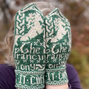 May include: A pair of green and white knitted mittens with a pattern of stylised trees and the text "It's Christmas Time" on the cuffs.