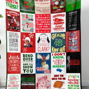 May include: A festive blanket with a patchwork design, featuring quotes and images from a Christmas film. The blanket has a green border and a variety of text and graphics in red, white, and green.