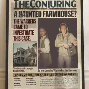 May include: A framed movie poster for "The Conjuring" with a black frame. The poster features the film's title, images of the actors, and the tagline "Evil Loves Innocence." The poster also includes the film's release year and runtime.