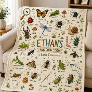 May include: A cream-colored throw blanket featuring a colorful insect collection print with the text ETHAN'S BUG COLLECTION Little Explorer. The design includes illustrations of a butterfly, ladybug, dragonfly, spider, snail, and various other bugs.