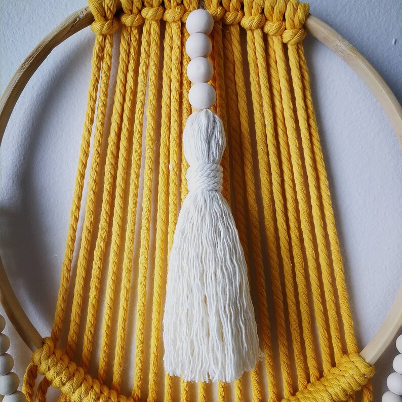 Macram\u00e9 wall suspension and wooden beads