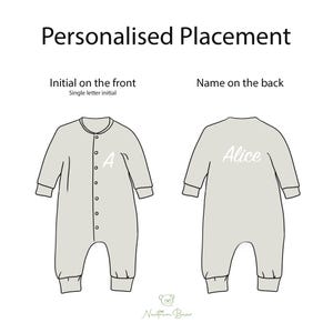May include: A light gray baby romper shown from the front and back. The front view displays a single letter initial A, while the back view features the name Alice in white script. The text Personalised Placement, Initial on the front, and Name on the back are visible above the illustrations.