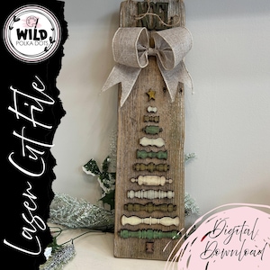 May include: A rustic wooden Christmas tree decoration with a burlap bow and star. The tree is made of various wooden shapes in shades of green and white. The words "WILD POLKA DOTS" and "Laser Cut File" are visible.