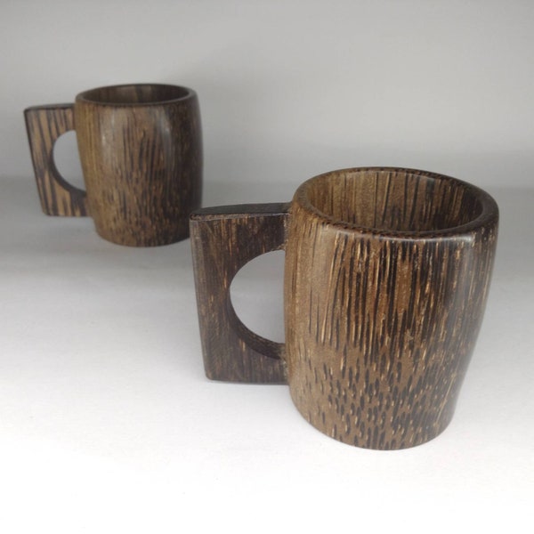 Enjoying rainy day with mist by taking a hot coffee in coffe mug made by palm wood