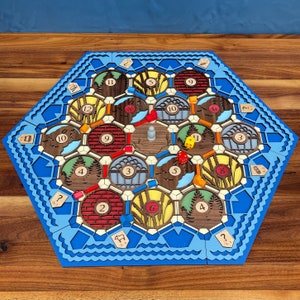 Home made catan board using perler/fuse beads. Turned resources into  physical tradable objects which are held in individual chests. All  discovery cards have been turned into black tokens that are drawn from