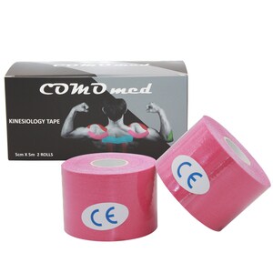 May include: Two pink kinesiology tape rolls with a white core and a blue CE mark on each roll. The tape is packaged in a black box with the brand name "COMD med" and the text "KINESIOLOGY TAPE" and "5cm X 5m 2 ROLLS".