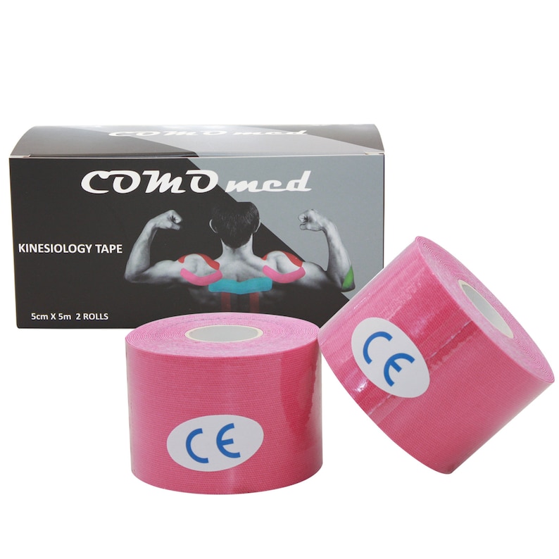 May include: Two pink kinesiology tape rolls with a white core and a blue CE mark on each roll. The tape is packaged in a black box with the brand name "COMD med" and the text "KINESIOLOGY TAPE" and "5cm X 5m 2 ROLLS".