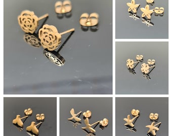 Collection of small golden steel earrings.