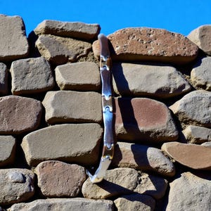 Two-tone flat bracelet in gold and silver stainless steel.