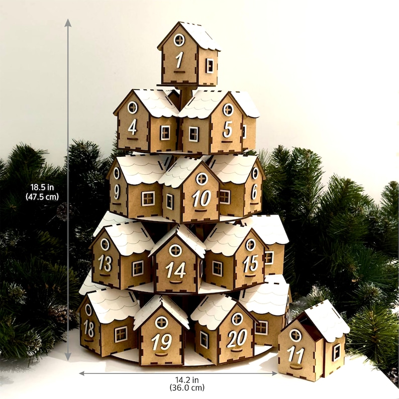 May include: A wooden Christmas advent calendar shaped like a tree with 20 small houses, each with a number from 1 to 20. The houses are stacked in a pyramid shape, with the top house being the smallest and the bottom houses being the largest. The houses are painted brown and have white roofs. The calendar is 18.5 inches tall and 14.2 inches wide.