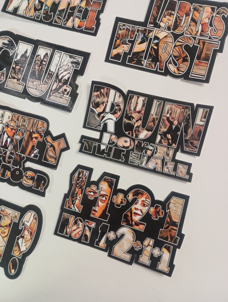 May include: A set of nine black and white stickers with images and text from the movie Clue. The stickers feature characters from the movie, including Miss Scarlet, Professor Plum, and Colonel Mustard. The text on the stickers includes phrases like "Ladies First", "Run Down the Hall", and "1+1=2+1 Not 1+2=1+1".