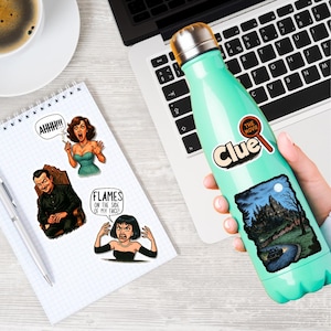 May include: A teal water bottle with a silver lid and a "Clue: The Movie" sticker. The image also shows stickers with comic book style illustrations and text, and a notebook with a pen.