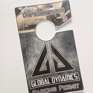 May include: A black and white parking permit with the text "GLOBAL DYNAMICS PARKING PERMIT" and the number "#071802071612".