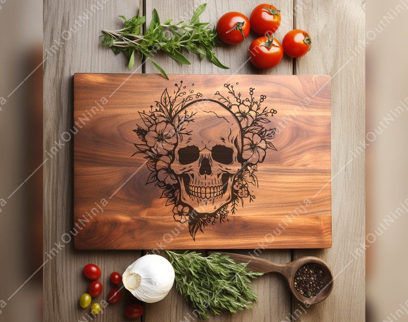 May include: A wooden cutting board with a floral design and a skull engraved in the center. The board is brown and has a natural wood grain.