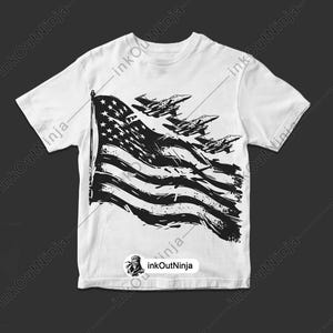 May include: White t-shirt with a black and white graphic of an American flag with fighter jets flying over it.