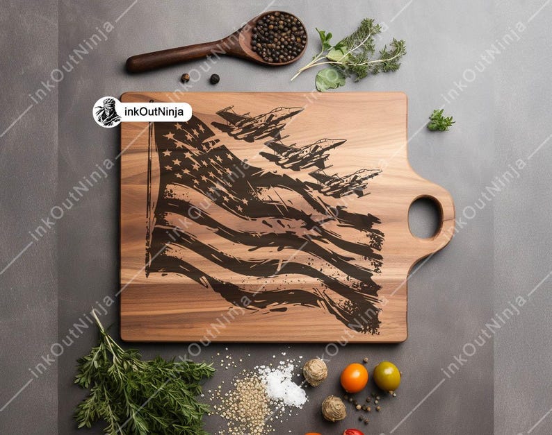 May include: A wooden cutting board with a handle, featuring a laser-engraved design of an American flag with fighter jets flying over it.