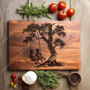 May include: A wooden cutting board with a laser-etched design of a tree with two children swinging on a swing. The board is brown and has a natural wood grain.