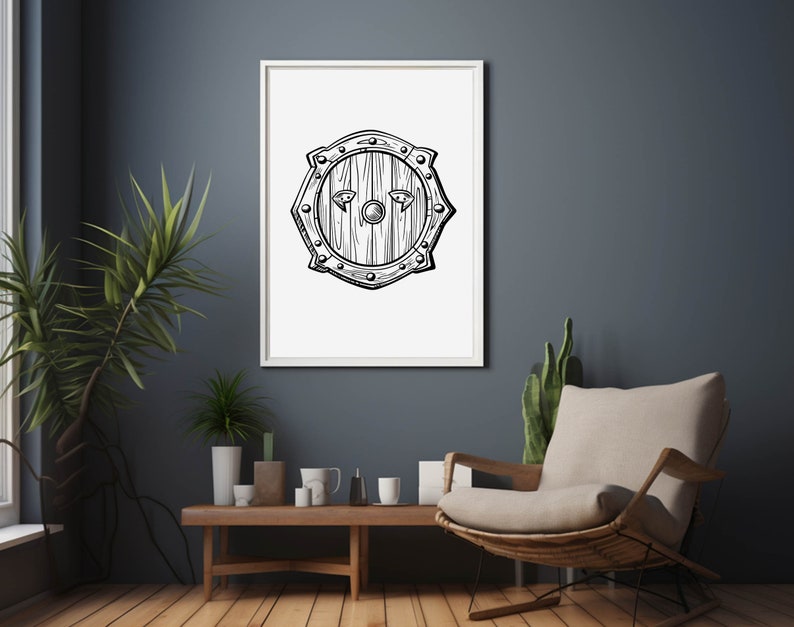 May include: A black and white line drawing of a round wooden shield with a central boss and metal accents. The shield is framed in a white frame and displayed on a dark blue wall.