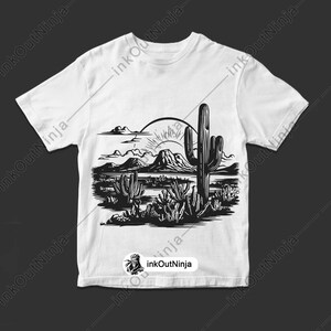 May include: A white t-shirt with a black and white illustration of a desert landscape with a large cactus in the center. The sun is setting behind the mountains in the background.