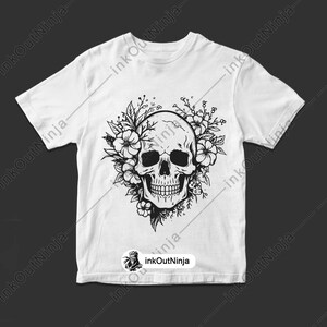 May include: A white t-shirt with a black and white graphic of a skull with flowers around it.