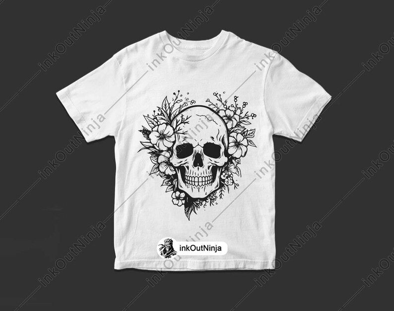 May include: A white t-shirt with a black and white graphic of a skull with flowers around it.