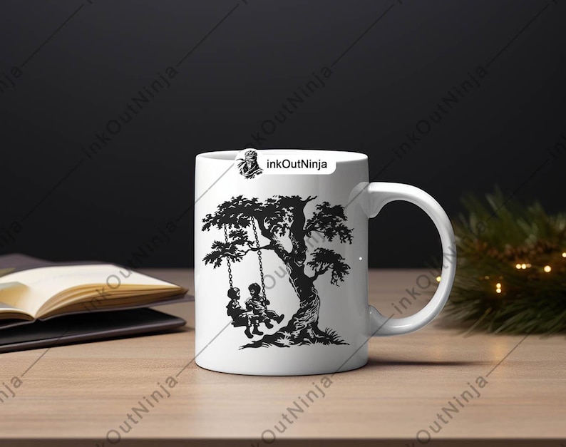 May include: White ceramic mug with a black silhouette design of two children on a swing under a tree. The text "InkOutNinja" is printed on the mug.