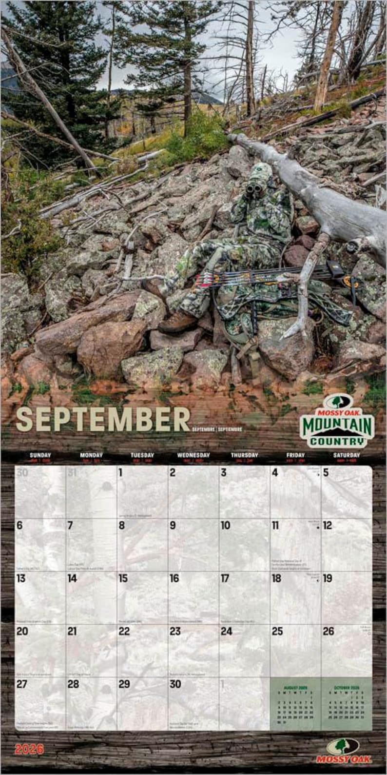 May include: A 2026 Mossy Oak Mountain Country calendar featuring a camouflage-clad person with a bow and arrow in a rocky, wooded setting. The September calendar page is visible, with a wooden textured border.