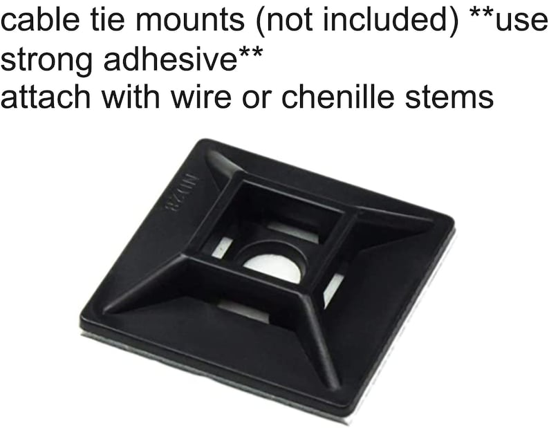 May include: Black plastic cable tie mount with adhesive backing. The mount has a square shape with a hole in the center and four smaller holes around the edges. The text "MZ24" is printed on the mount.