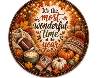 May include: Circular autumn-themed design with the text "It's the most wonderful time of the year." Features a football, coffee cup, pumpkins, mittens, and a knit hat. The border is brown with a dotted pattern and autumn leaves.