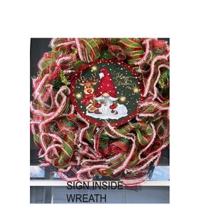 A wreath made of colorful ribbons and featuring a gnome and a reindeer design, with the text "Merry Christmas" displayed on it.