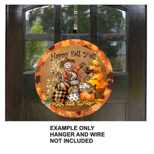 May include: A round, wooden door hanger with a fall theme. It features a scarecrow holding a pumpkin, surrounded by pumpkins and fall leaves. The text "Happy Fall Y'all" is written in a whimsical font.
