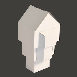 May include: A white cardboard model of a house with a simple design. The house is made of several stacked boxes, creating a layered effect.