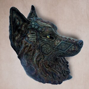 Detailed beaded wolf head sculpture featuring intricate patterns in vibrant shades of blue, green, and purple. The wolf’s striking green eyes create a captivating focal point. Handcrafted with glass seed beads, this textured and dimensional piece brings depth and brilliance to any space. Perfect as wall decor, this Huichol (Wixárika)-inspired artwork blends Mexican folk art, spiritual symbolism, and artisan craftsmanship—ideal for collectors and lovers of unique handmade decor.