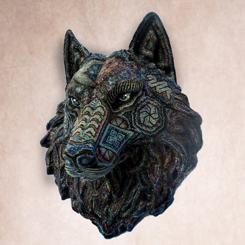 Detailed beaded wolf head sculpture featuring intricate patterns in vibrant shades of blue, green, and purple. The wolf’s striking green eyes create a captivating focal point. Handcrafted with glass seed beads, this textured and dimensional piece brings depth and brilliance to any space. Perfect as wall decor, this Huichol (Wixárika)-inspired artwork blends Mexican folk art, spiritual symbolism, and artisan craftsmanship—ideal for collectors and lovers of unique handmade decor.