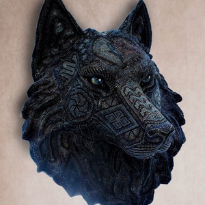 Detailed beaded wolf head sculpture featuring intricate patterns in vibrant shades of blue, green, and purple. The wolf’s striking green eyes create a captivating focal point. Handcrafted with glass seed beads, this textured and dimensional piece brings depth and brilliance to any space. Perfect as wall decor, this Huichol (Wixárika)-inspired artwork blends Mexican folk art, spiritual symbolism, and artisan craftsmanship—ideal for collectors and lovers of unique handmade decor.