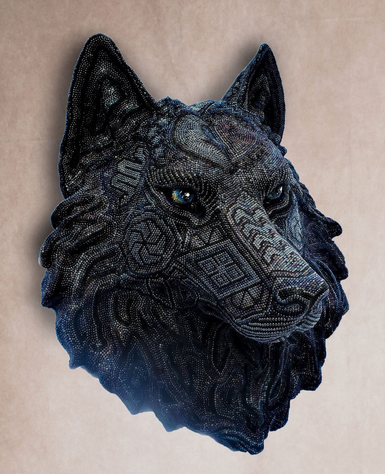 Detailed beaded wolf head sculpture featuring intricate patterns in vibrant shades of blue, green, and purple. The wolf’s striking green eyes create a captivating focal point. Handcrafted with glass seed beads, this textured and dimensional piece brings depth and brilliance to any space. Perfect as wall decor, this Huichol (Wixárika)-inspired artwork blends Mexican folk art, spiritual symbolism, and artisan craftsmanship—ideal for collectors and lovers of unique handmade decor.