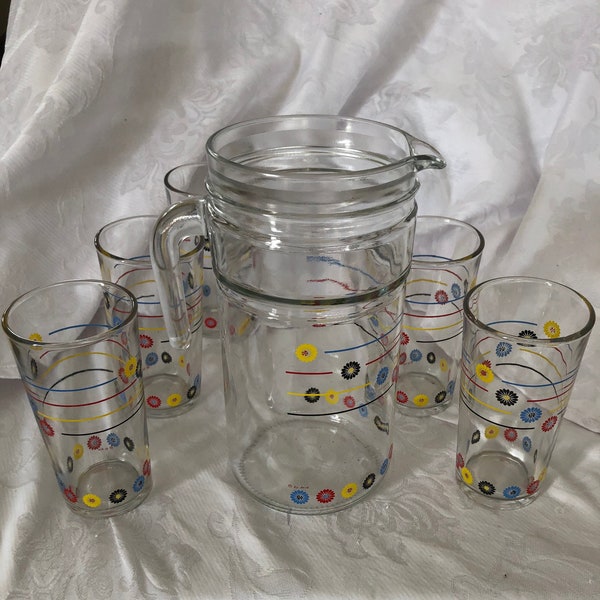 An Italian made glass pitcher with 5 matching glasses c 1970s the pitcher and the glasses in bright summer colours. Mid Century Modern Look.