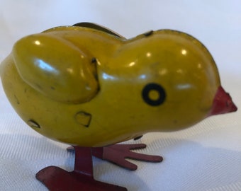 A vintage windup toy of a pecking yellow chick c. 1950 preowned, played with in fair condition, may be British made. Procured in the UK.