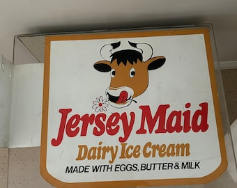 A vintage c1980 Jersey Maid Ice Cream advertising sign in very good condition was used in a defunct café in Gorey on the Island of Jersey.